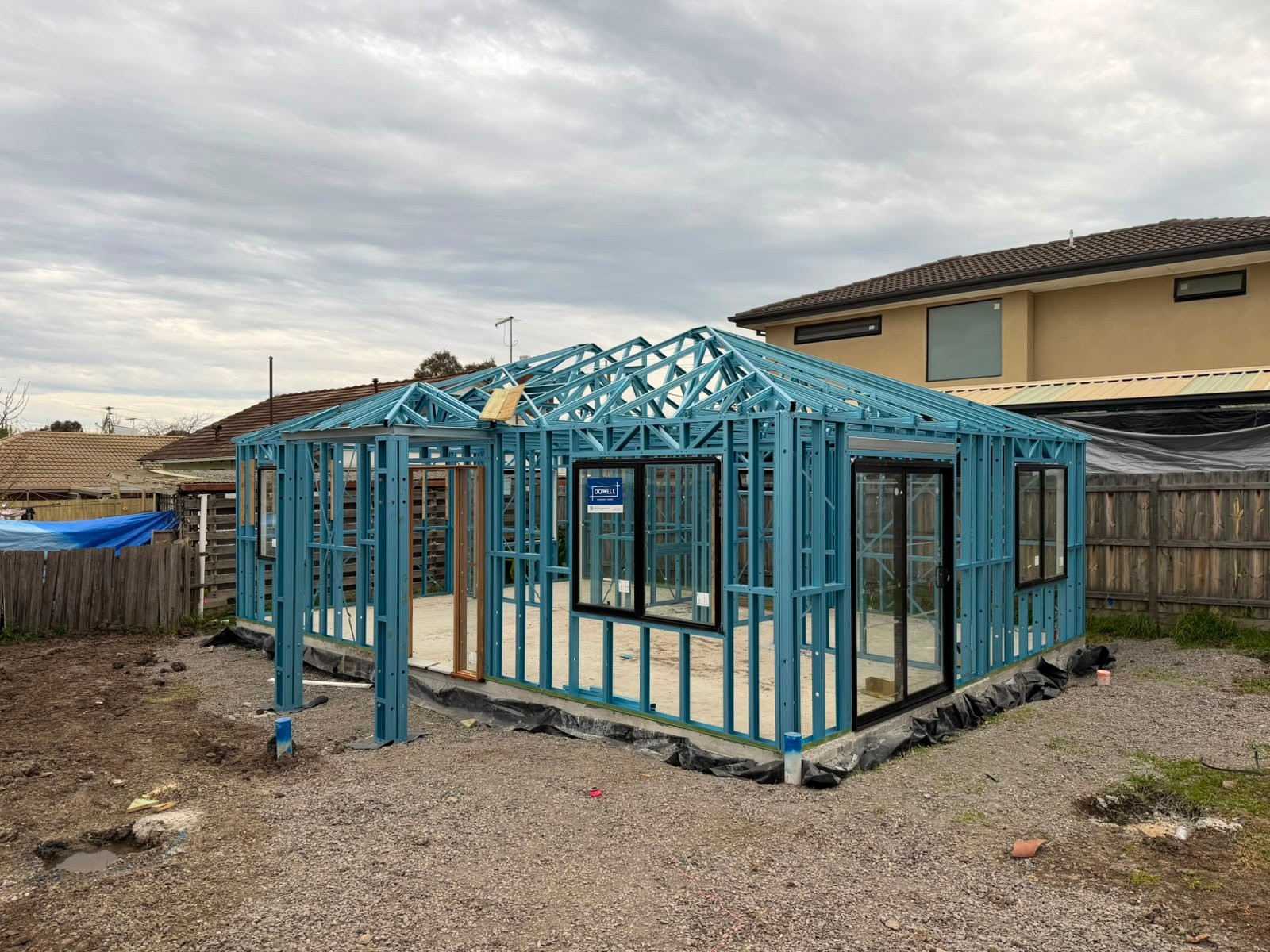 Completed light gauge steel frame with wall frames and hip roof trusses installed by KM Steel Framing in Victoria