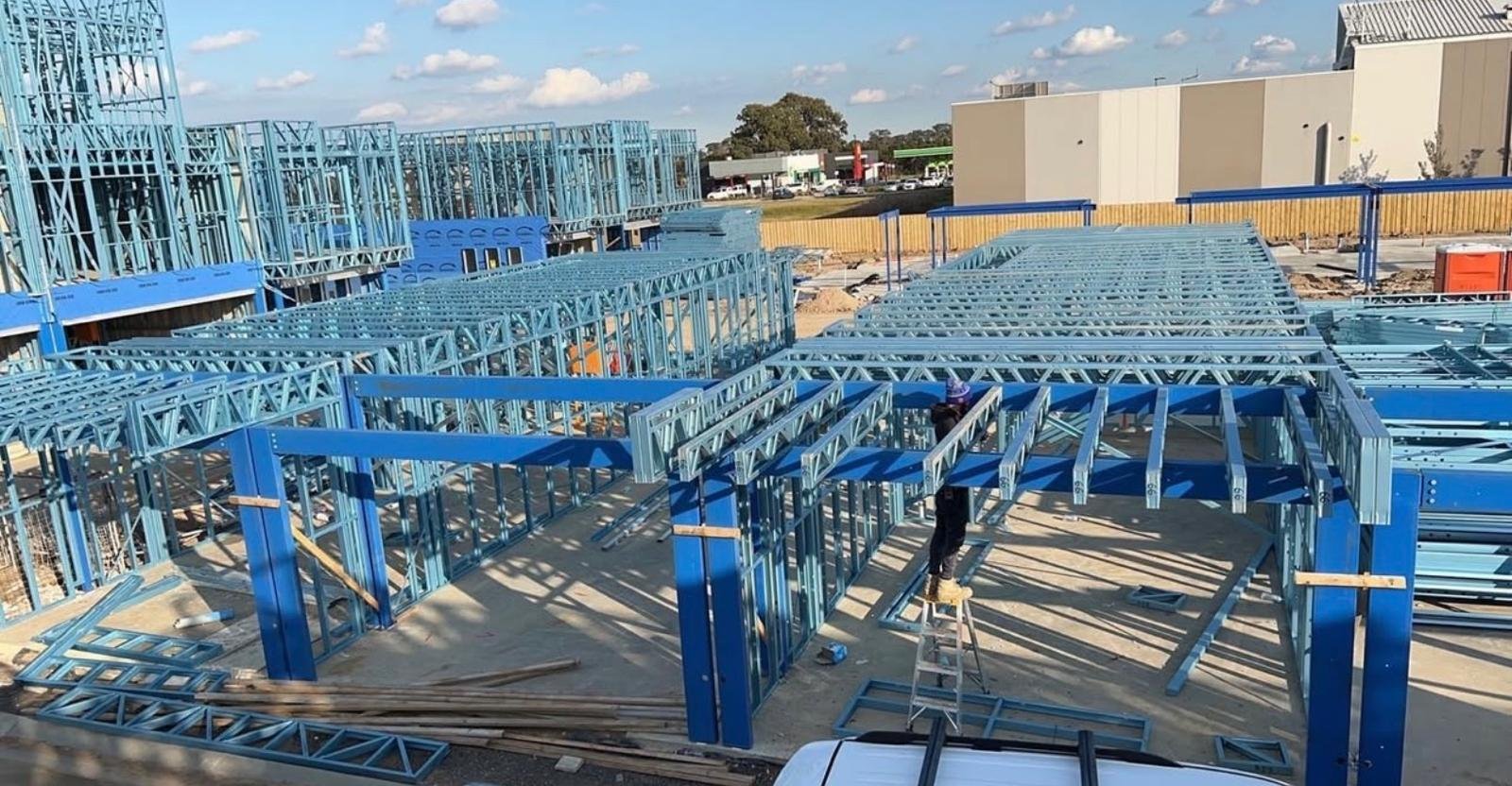 Ground-floor steel wall frames and floor system across a large multi-unit site in Victoria